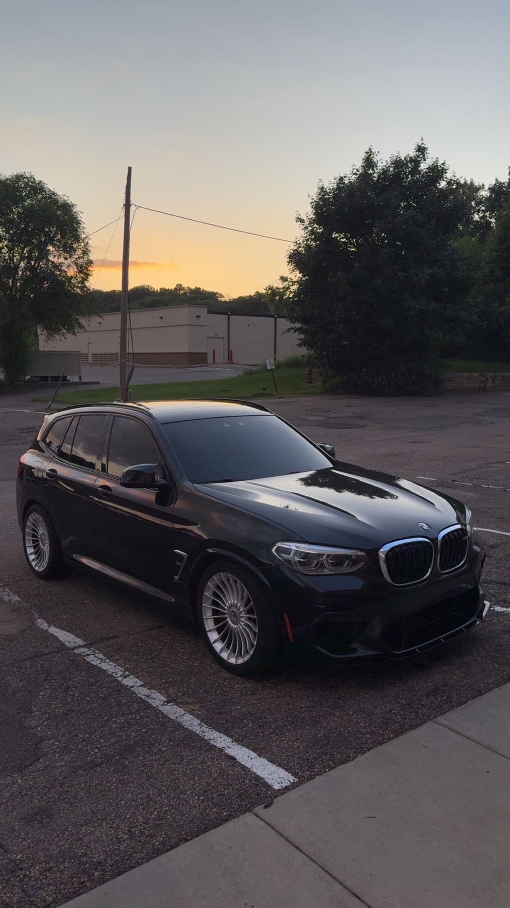 BMW X3 with professionally installed window tint at dusk